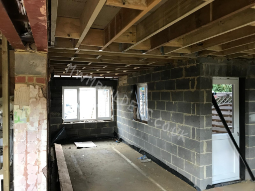 Interior of a partially constructed room with exposed walls and framing.