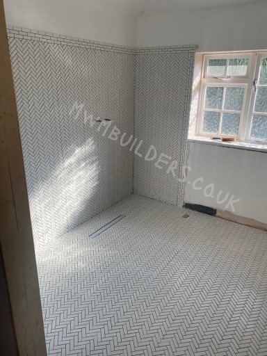 Empty room with tiled floor, featuring a window and natural light.